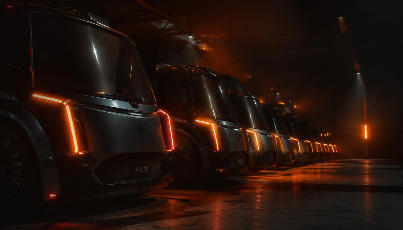 Concept rendering of autonomous vehicles lined up in a dark depot with orange accent lighting